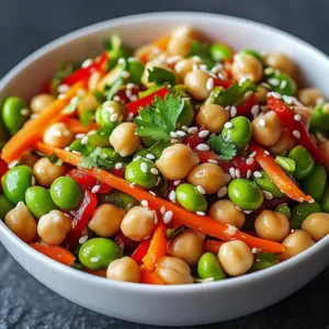 Chickpea Edamame Salad with Ginger Sesame served in a bowl garnished with sesame seeds
