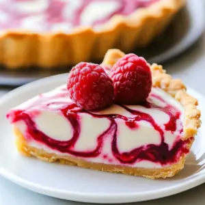 Chilled Raspberry Lemonade Pie topped with fresh raspberries and lemon slices