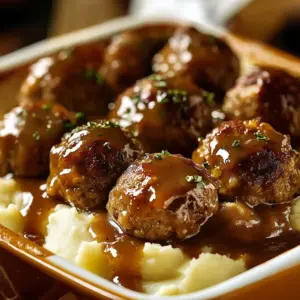 A delicious serving of meatballs with a creamy mashed potato bake