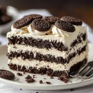 No-Bake Oreo Refrigerator Cake topped with crushed Oreos and chocolate